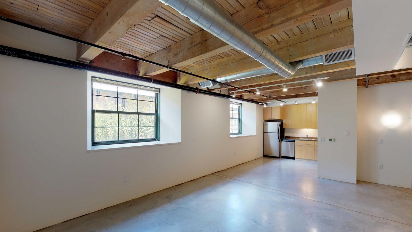 Contemporary one-bedroom with stainless steel appliances and granite countertops at Tobacco Lofts