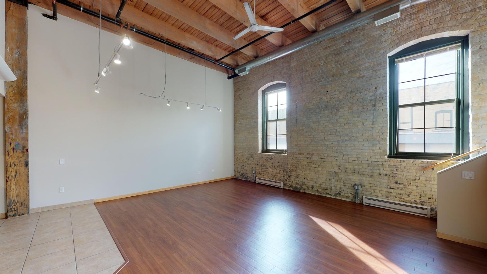 Two bedroom loft apartment with dramatic high ceilings and historic timber beams at Tobacco Lofts