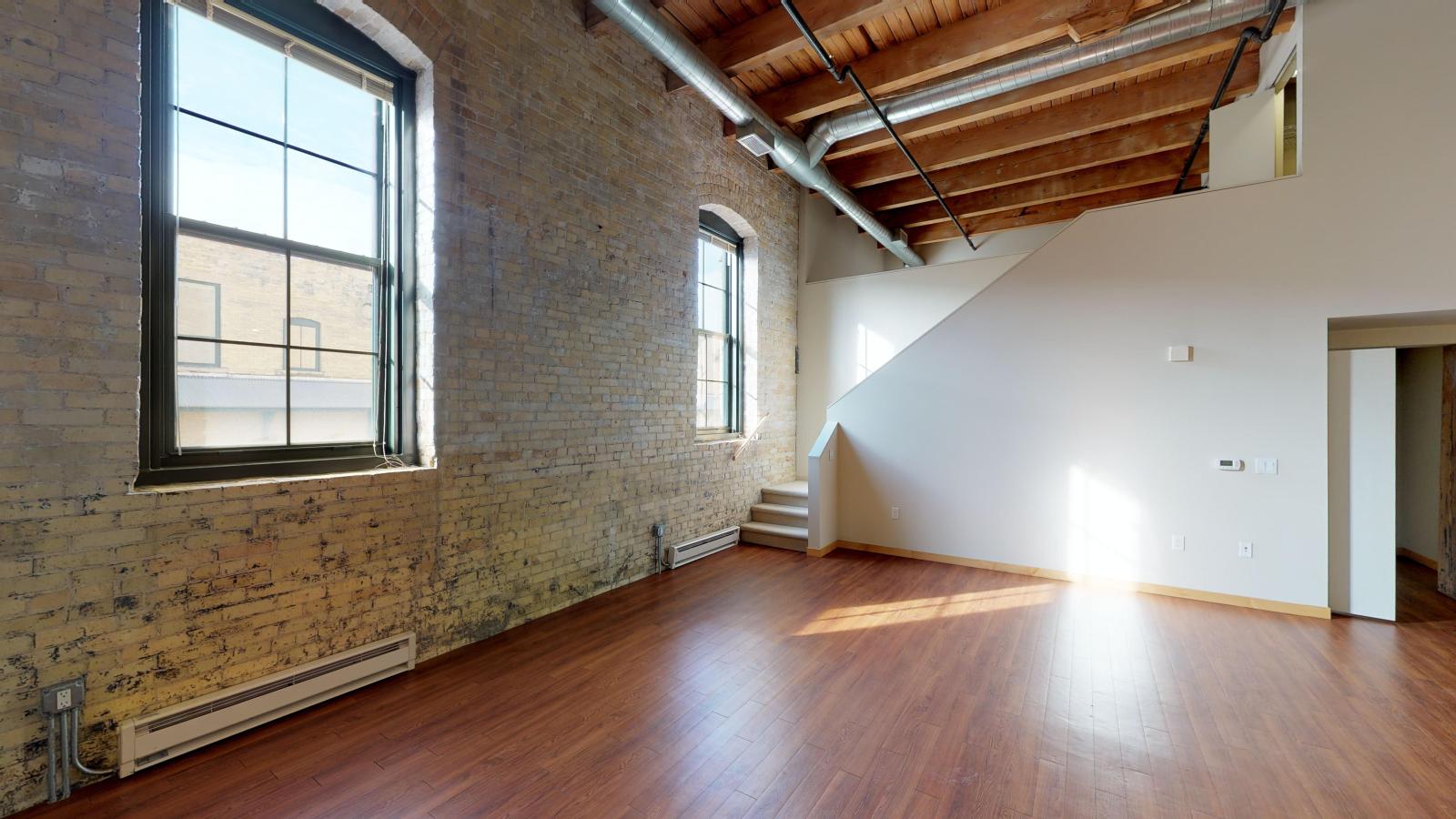 Two bedroom with historic character, high ceilings, and a lofted second bedroom at Tobacco Lofts