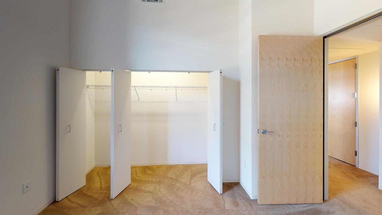 Industrial style one bedroom with expansive windows allowing abundant natural light at Tobacco Lofts