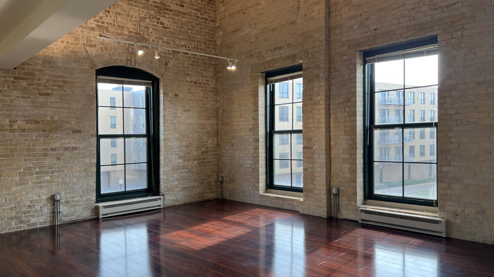 Two bedroom loft with original exposed brick and contemporary updates at Tobacco Lofts at The Yards in downtown Madison