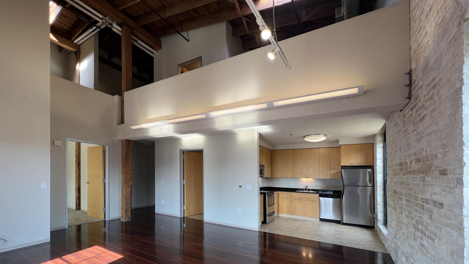 Historic two bedroom apartment featuring open loft style design and preserved architectural details at Tobacco Lofts at The Yards in downtown Madison