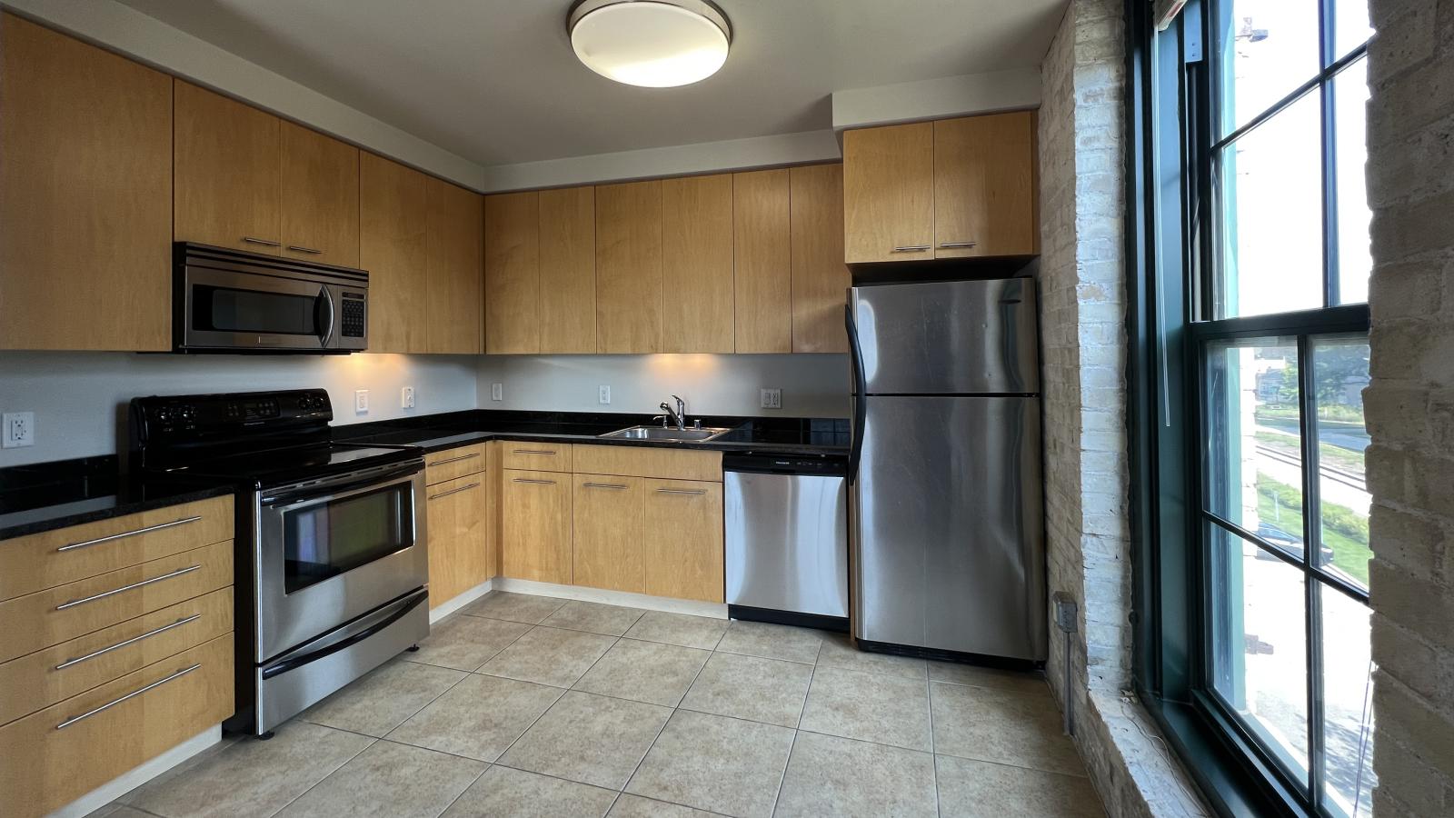 Lofted two bedroom with a spacious kitchen modern appliances at Tobacco Lofts at The Yards in downtown Madison