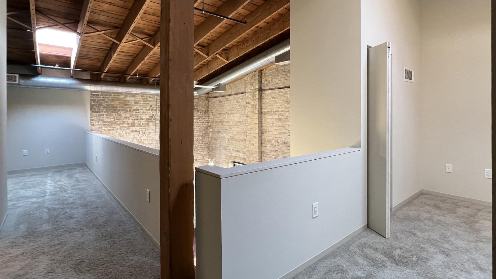 Two bedroom apartment with an upstairs ensuite bathroom featuring soft industrial accents at Tobacco Lofts at The Yards in downtown Madison