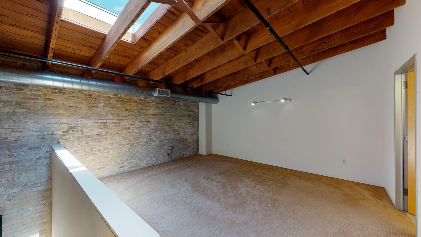 Two bedroom loft featuring large closets and high ceilings and skylights at Tobacco Lofts at The Yards in downtown Madison