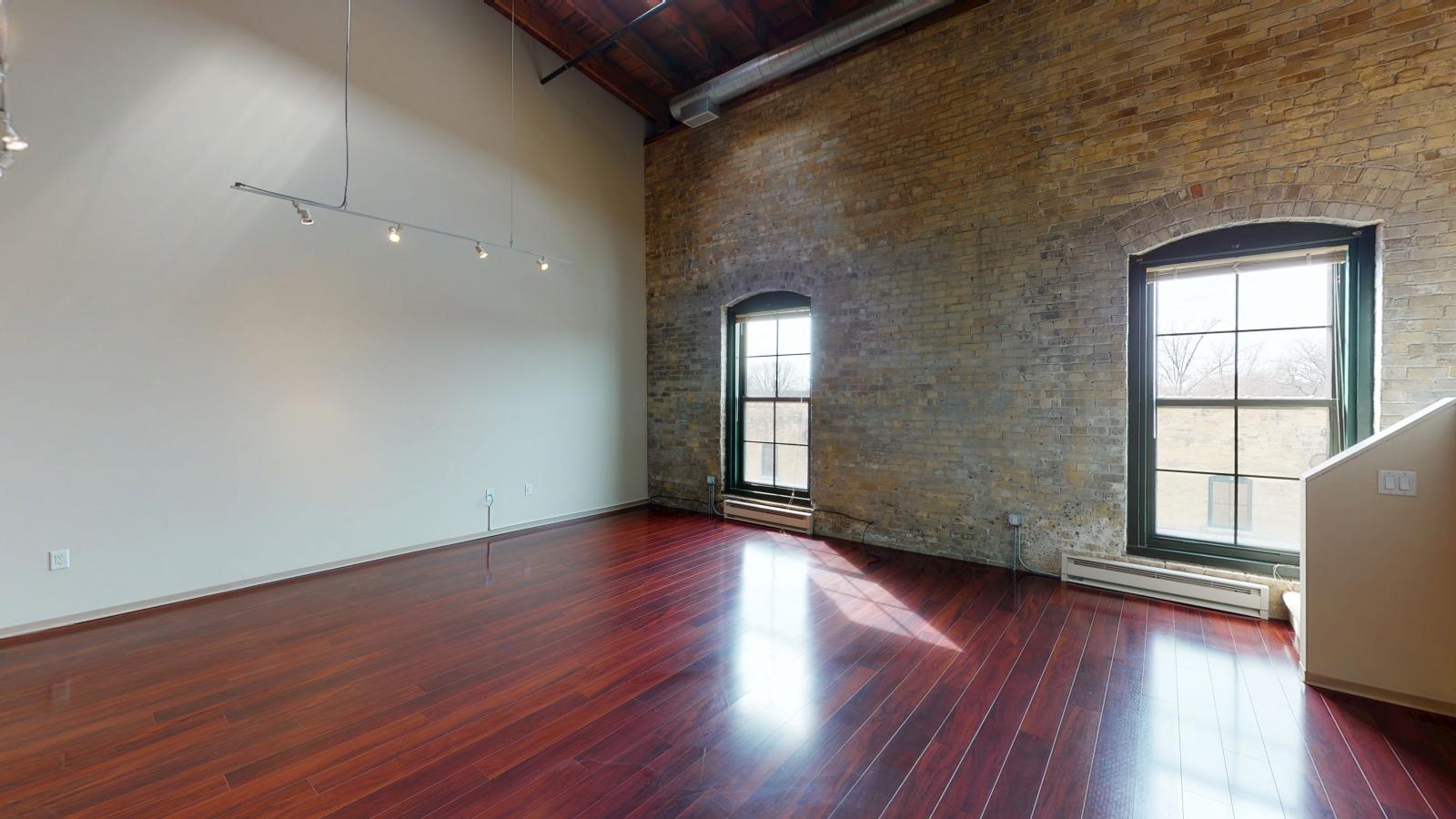 Bright two bedroom apartment with oversized industrial style windows and abundant natural light at Tobacco Lofts at The Yards in downtown Madison