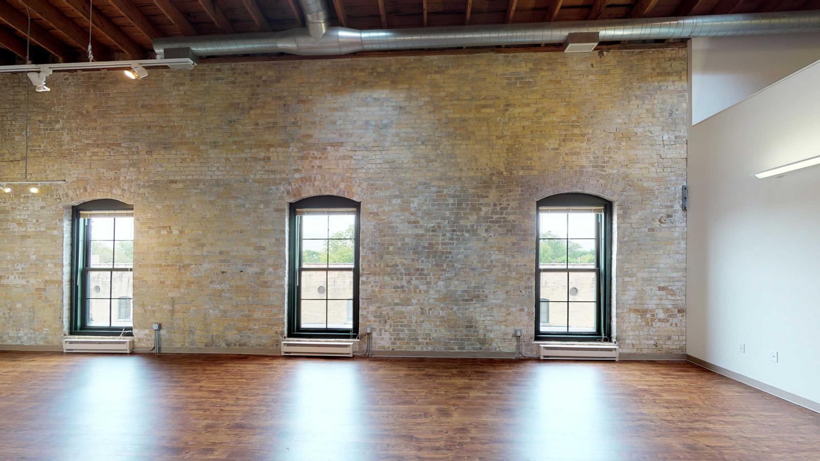 Two bedroom loft apartment with dramatic high ceilings and historic timber beams at Tobacco Lofts