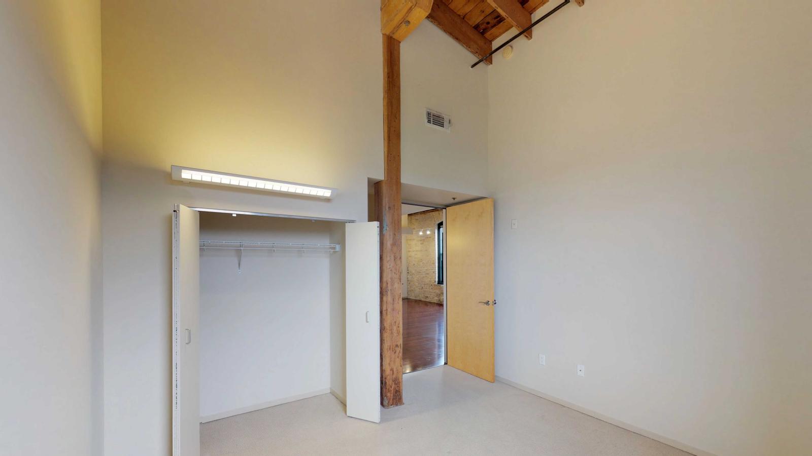 Two bedroom loft featuring large windows high ceilings and ample closet space at Tobacco Lofts