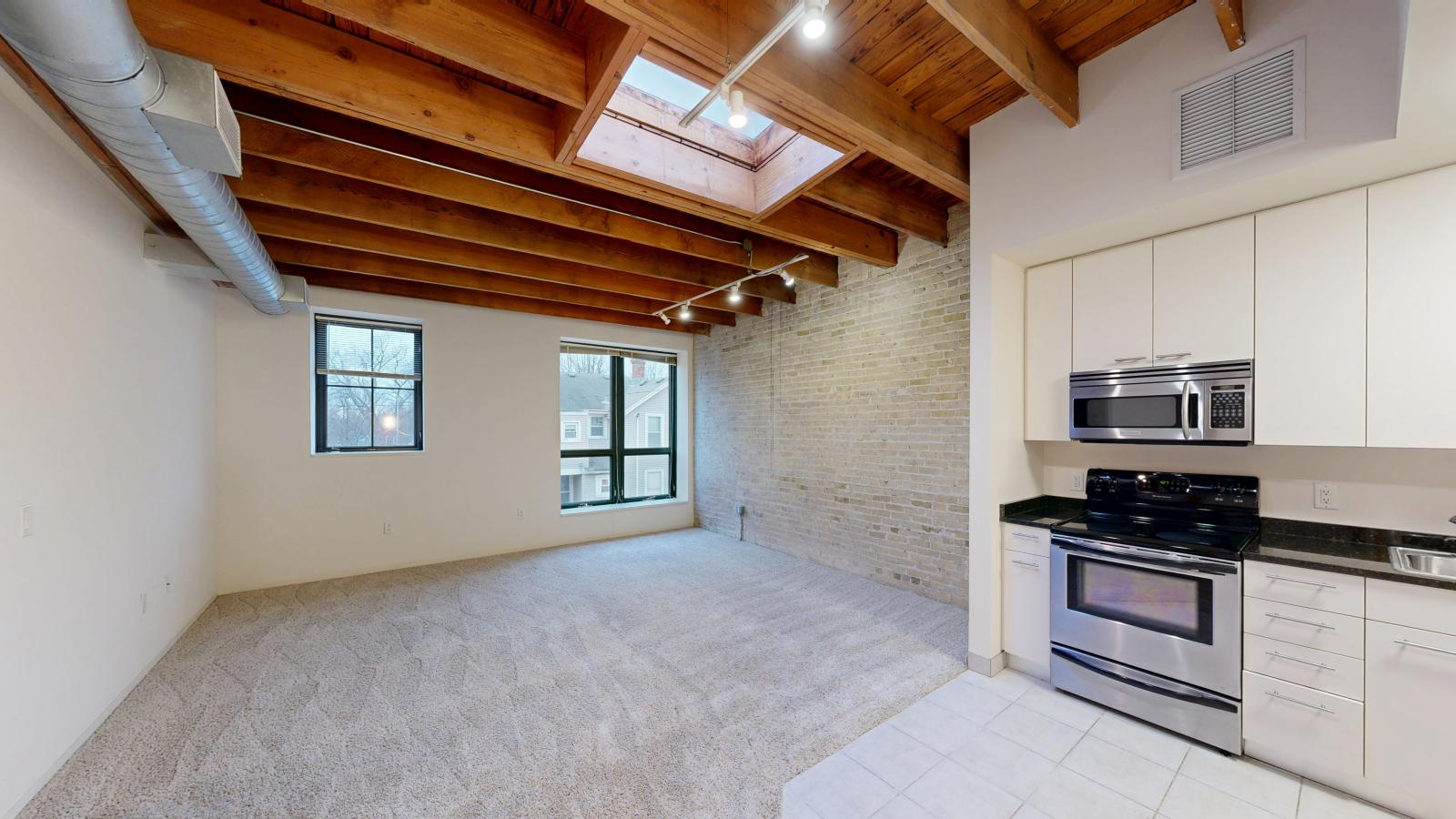 Bright one bedroom apartment with skylight, exposed brick, and high ceilings at Tobacco Lofts at The Yards in downtown Madison