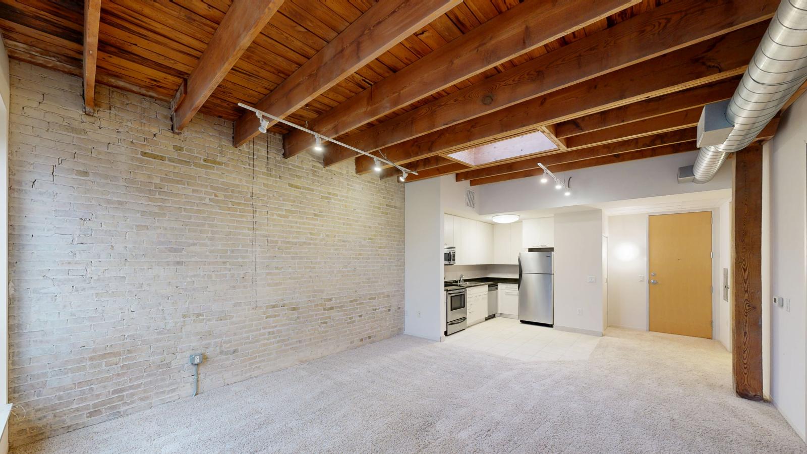 Bright one bedroom apartment with skylight, exposed brick, and high ceilings at Tobacco Lofts at The Yards in downtown Madison