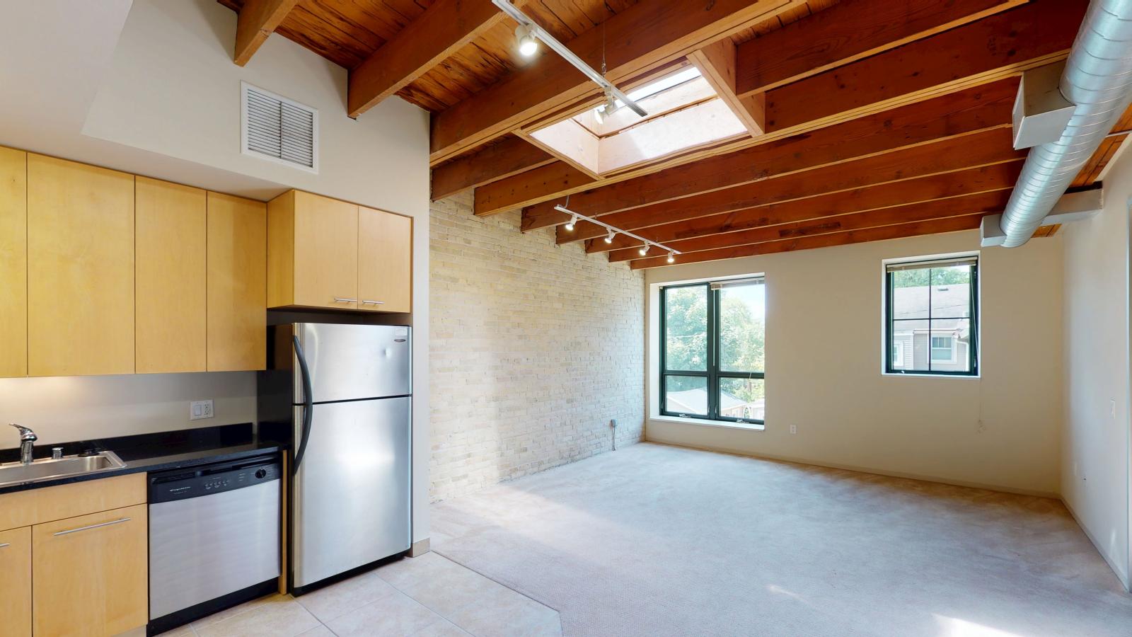 Bright one bedroom apartment with skylight, exposed brick, and high ceilings at Tobacco Lofts at The Yards in downtown Madison