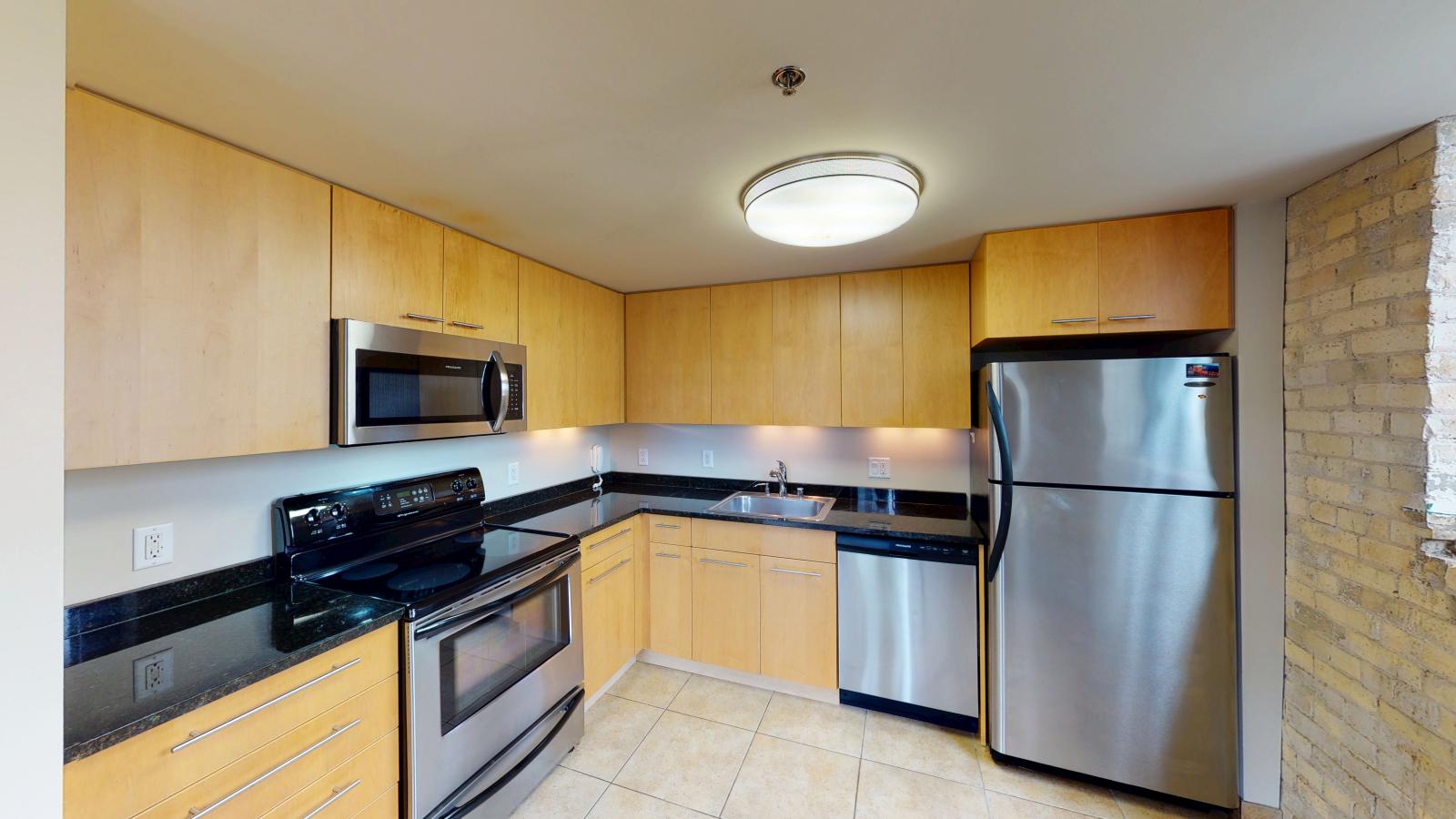 Lofted two bedroom with a spacious kitchen modern appliances at Tobacco Lofts Apartment E201