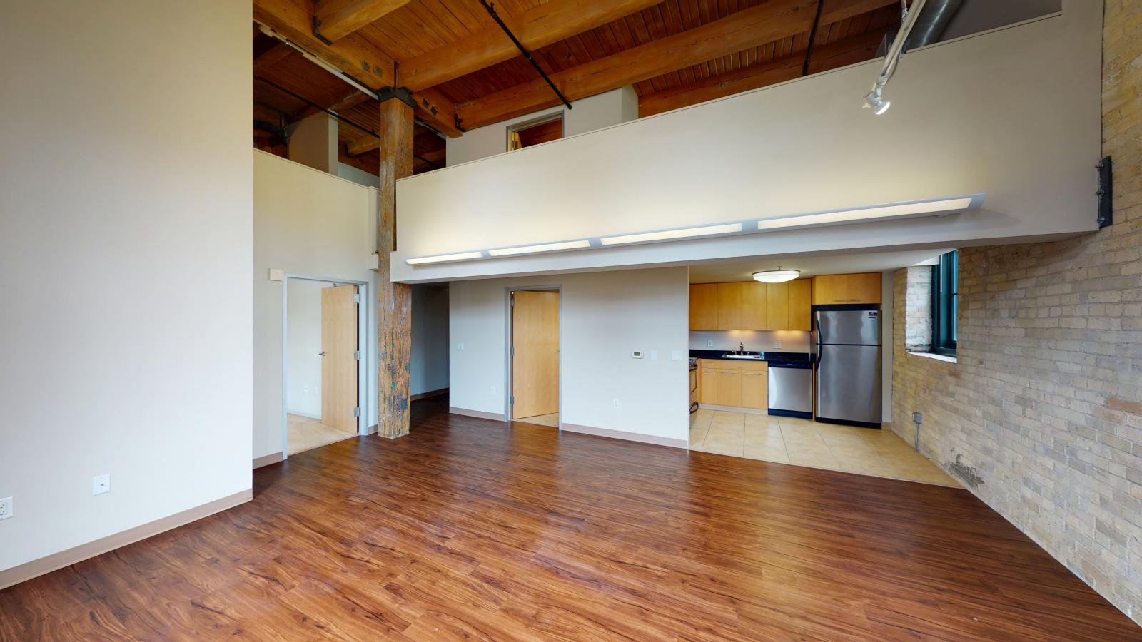 Two bedroom loft featuring large windows high ceilings at Tobacco Lofts Apartment E201