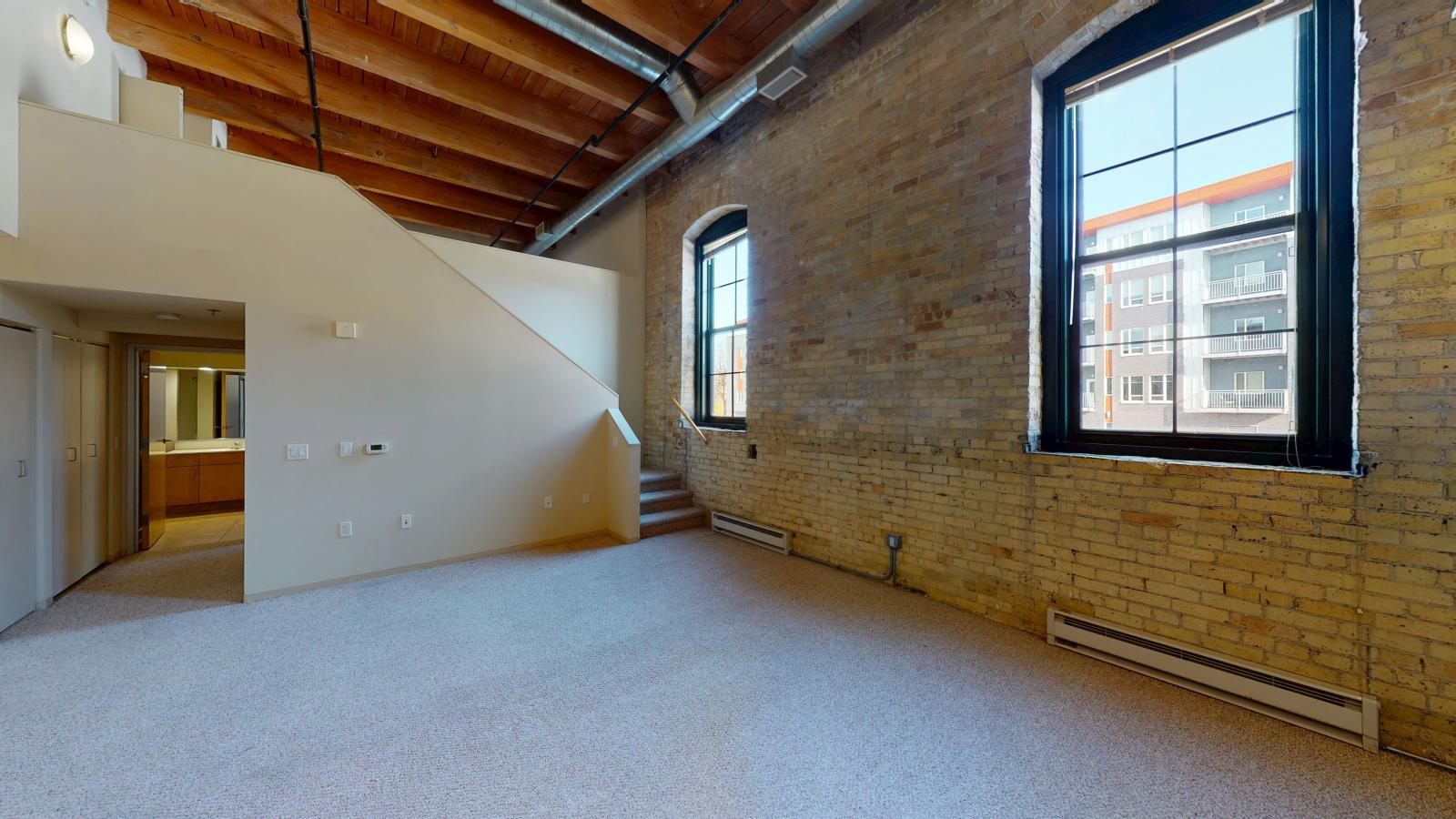 Lofted two bedroom with historic features and soft industrial finishes at Tobacco Lofts Apartment E205