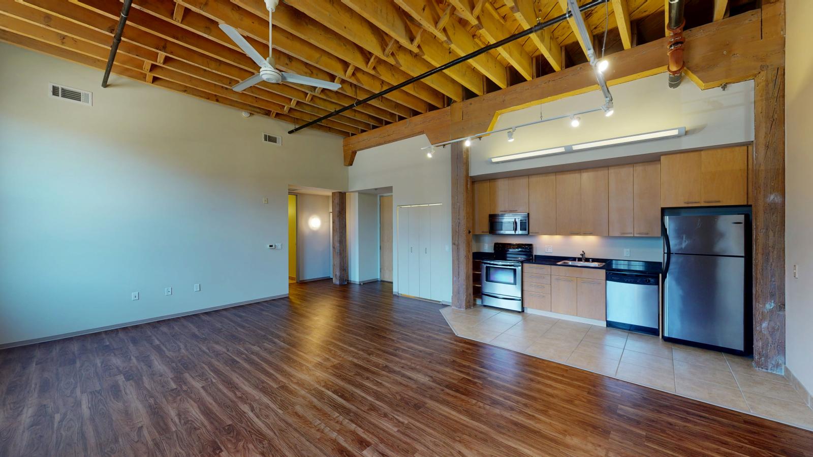 Contemporary kitchen in a one bedroom apartment with ample counter space at Tobacco Lofts at The Yards in downtown Madison