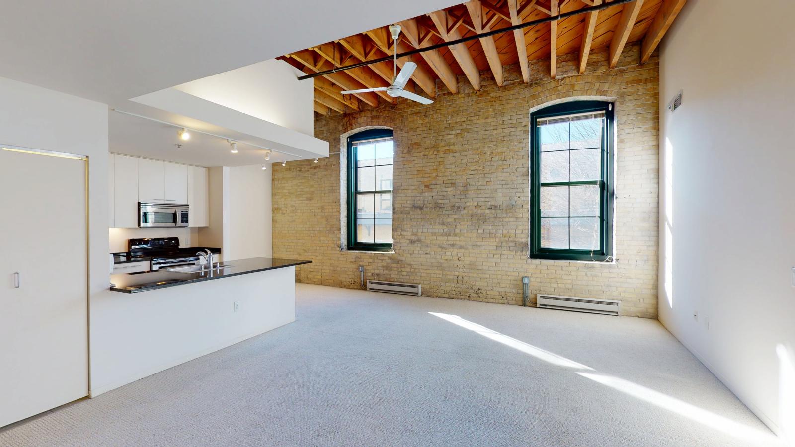 Two bedroom apartment with exposed brick high ceilings and industrial design at Tobacco Lofts at The Yards in downtown Madison