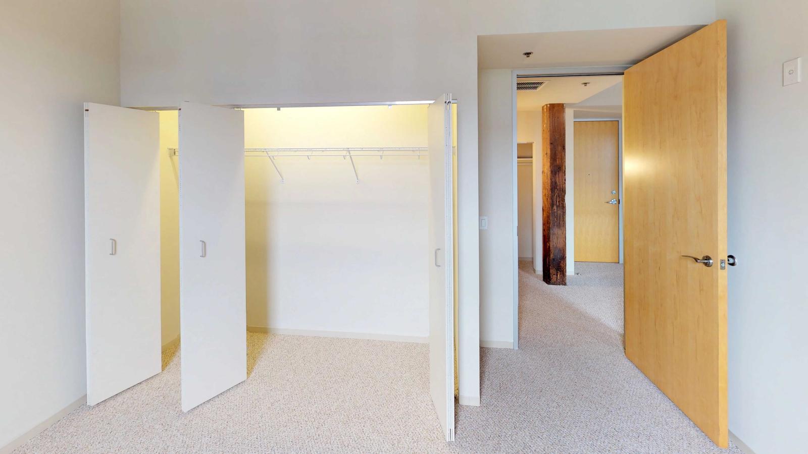 One bedroom with original wood ceilings and modern fixtures at Tobacco Lofts
