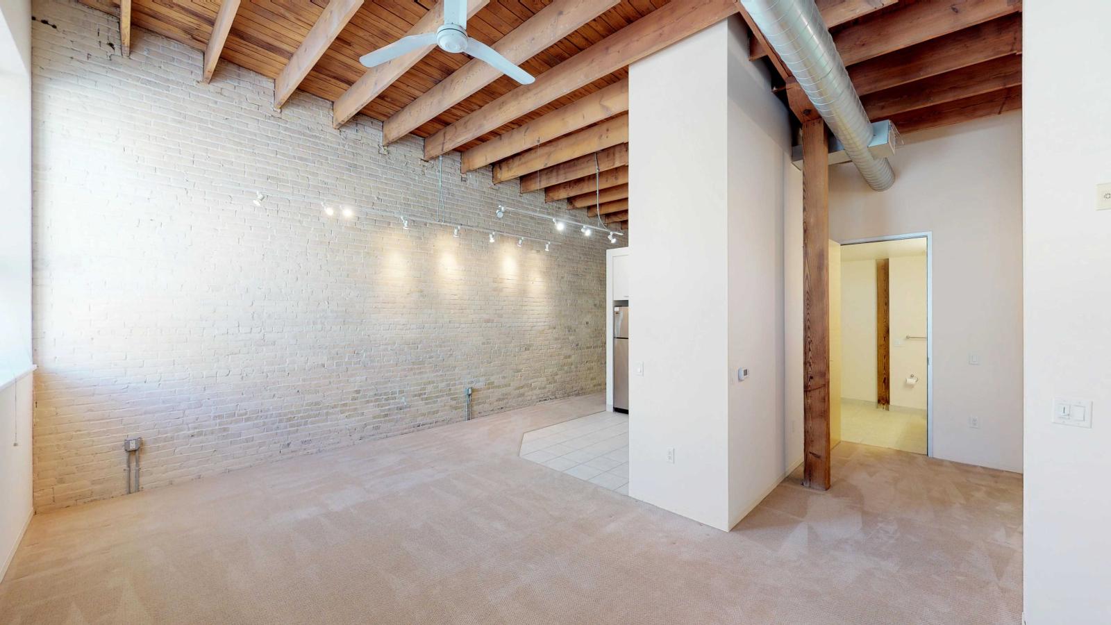 Studio with abundant natural light and industrial-style charm at Tobacco Lofts