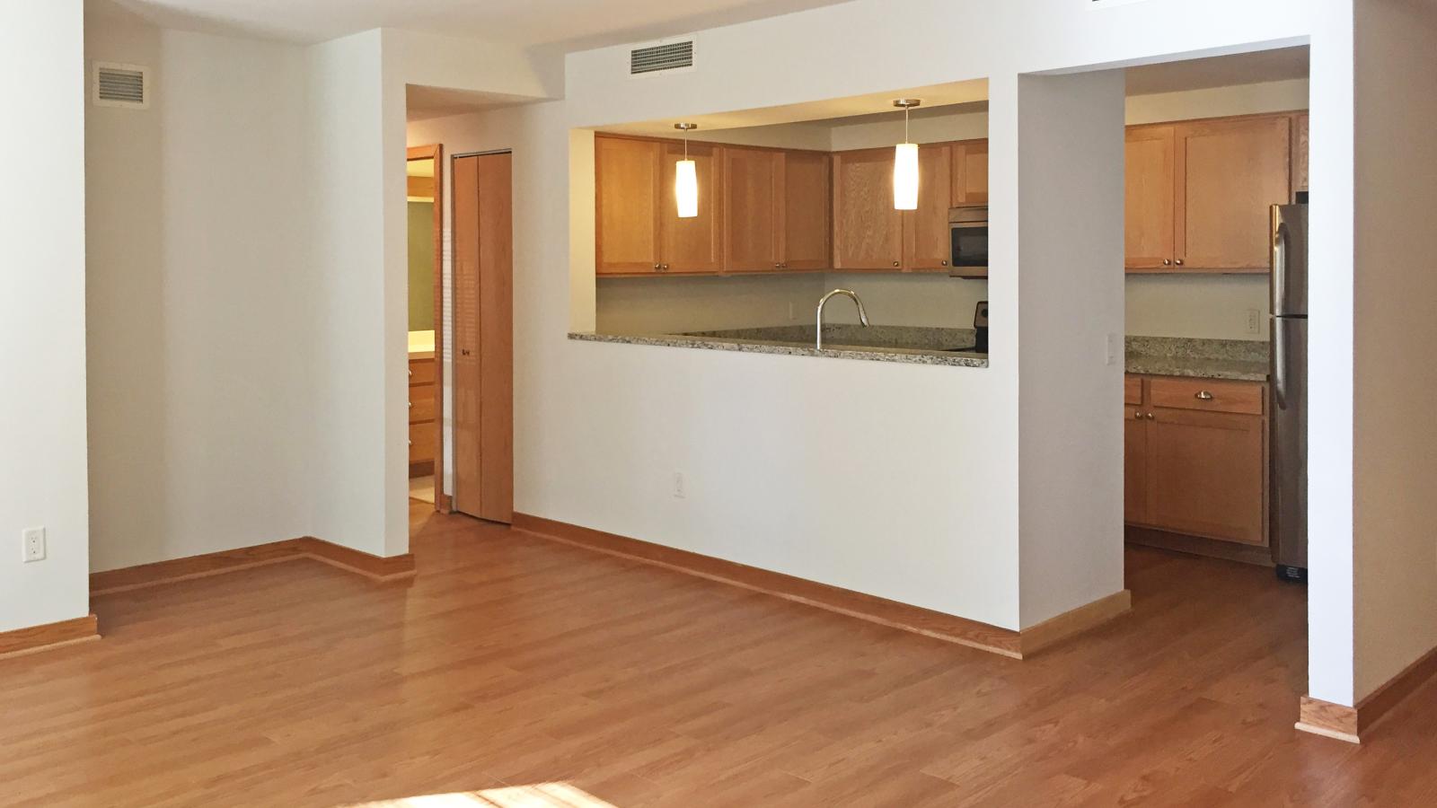 Spacious two-bedroom apartment living room with large windows, private patio and natural light at Lincoln School