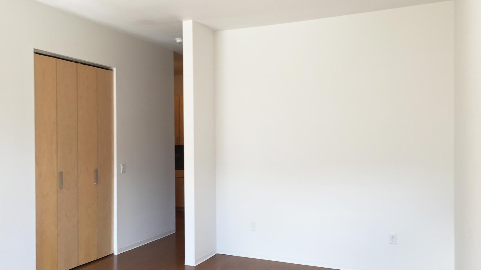 Cozy sleeping area with large windows and natural light in a studio at SEVEN27