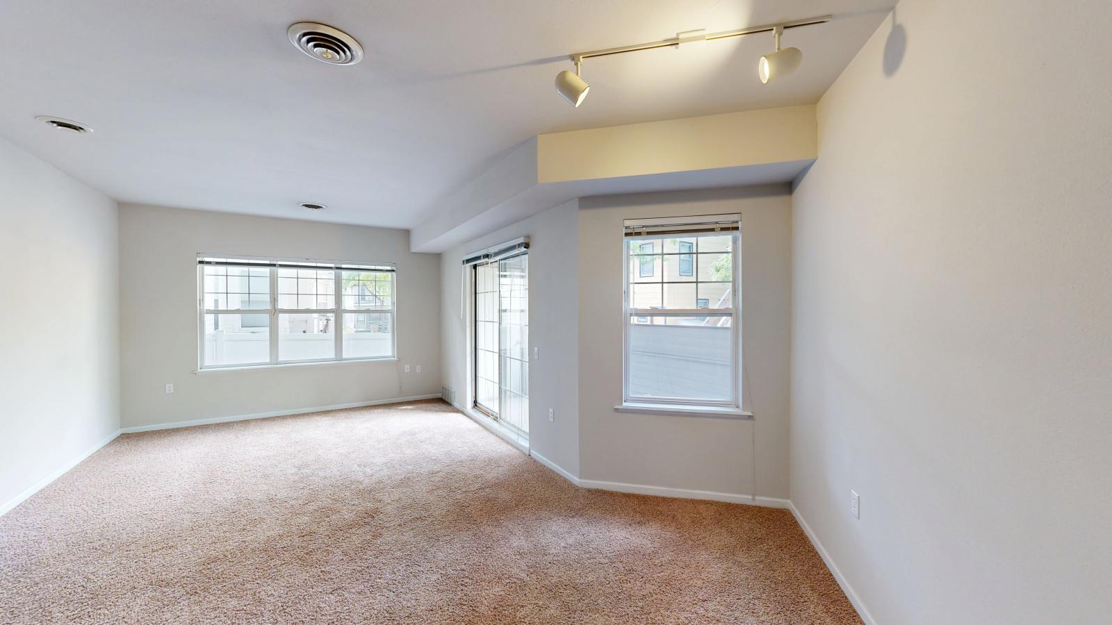 Cozy living room with soft finishes and a private balcony at Wilson Bay Apartment 101