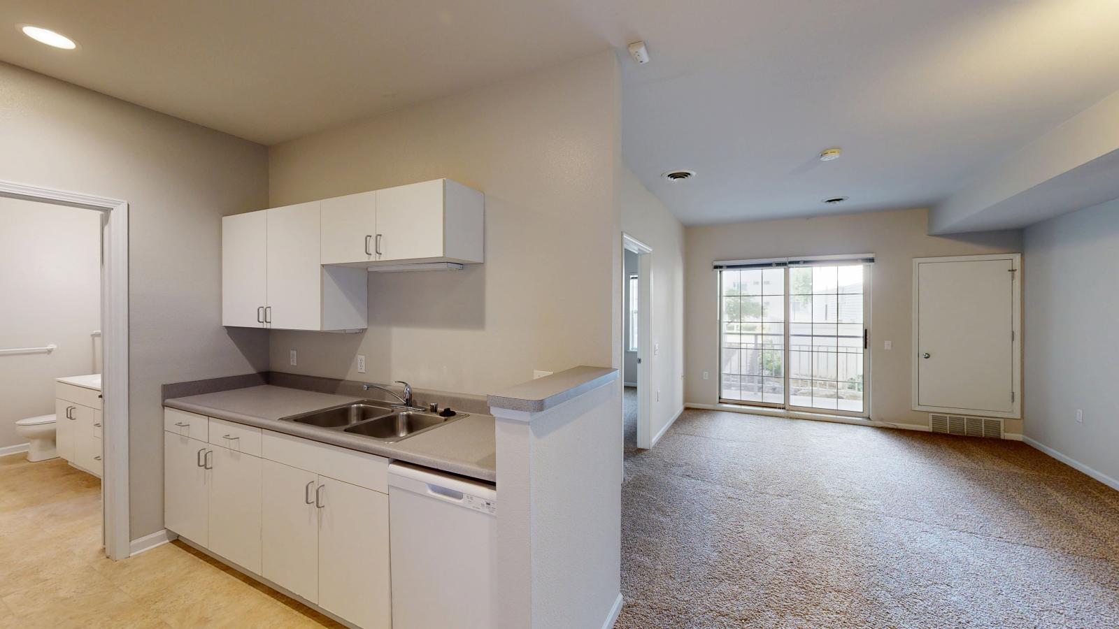 Kitchen with classic cabinetry and full-size appliances in a one-bedroom apartment at Wilson Bay.