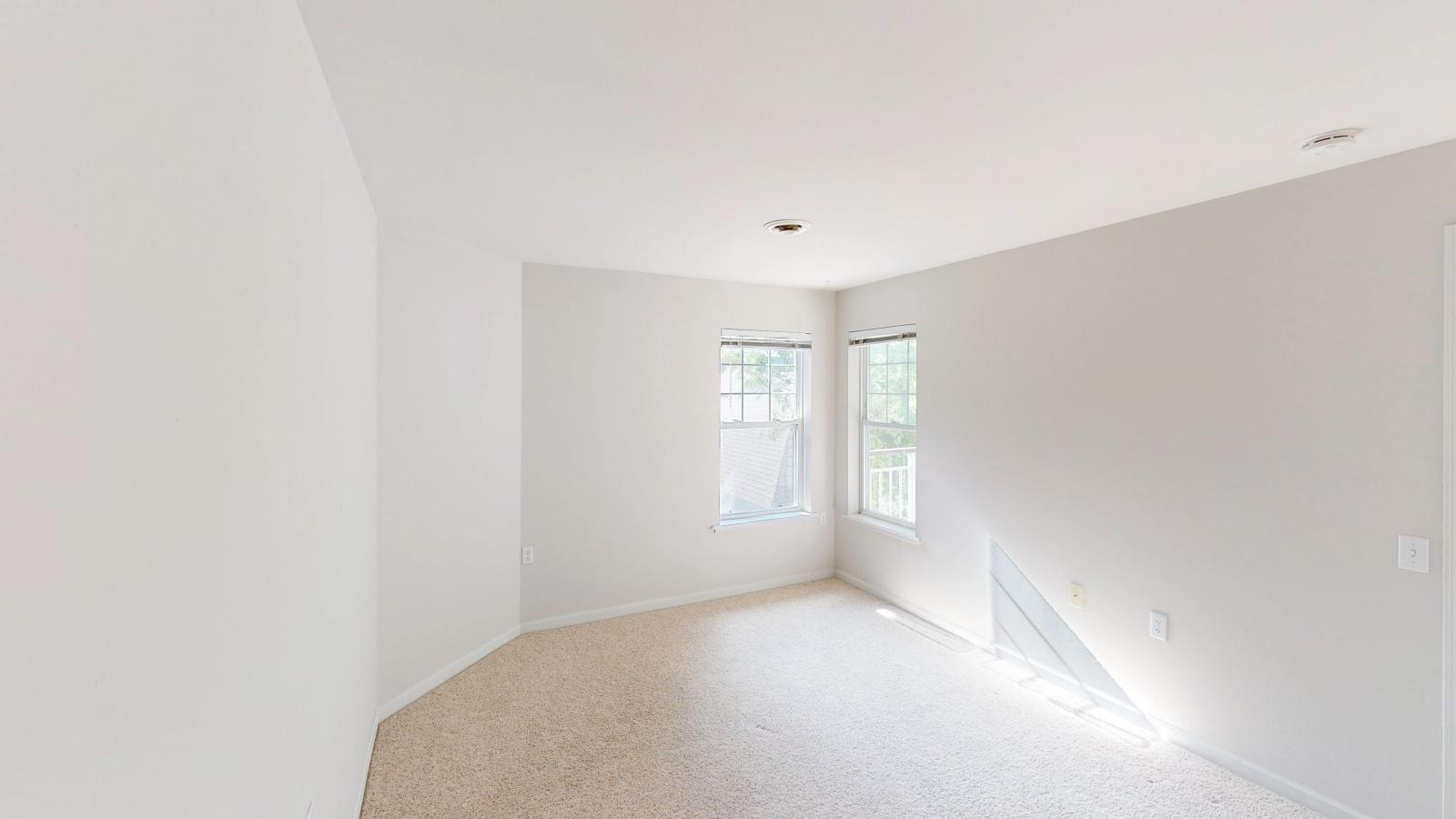 Spacious bedroom with a large closet and natural light at Wilson Bay Apartments