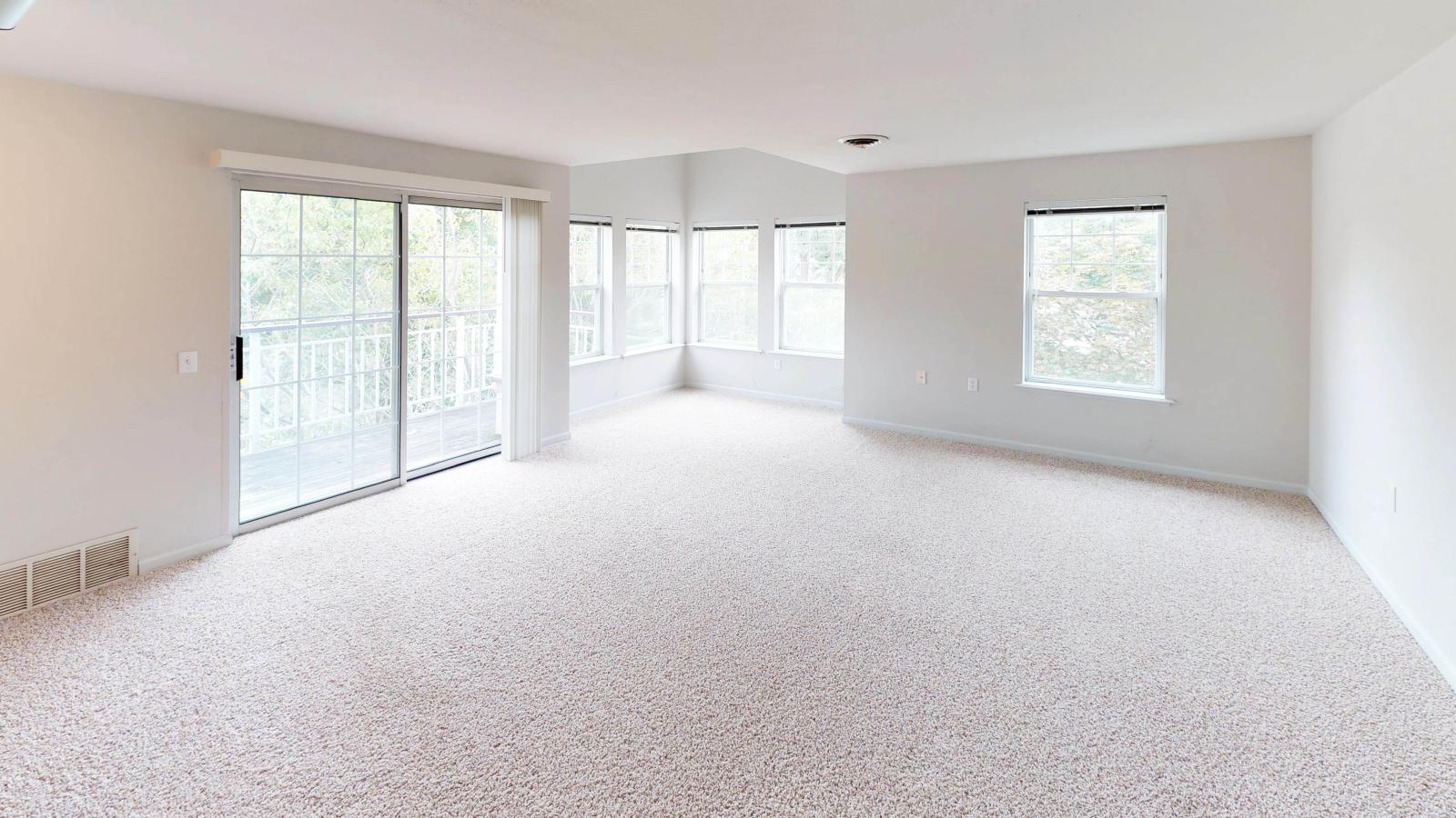 Spacious living room with abundant natural light and classic design in a two-bedroom at Wilson Bay
