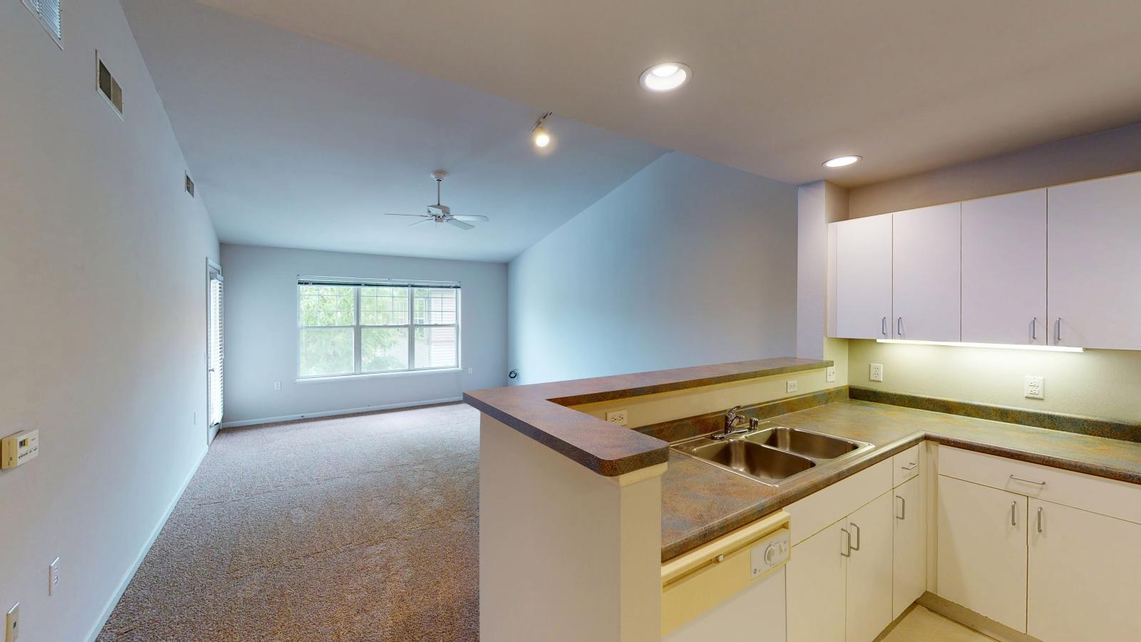 Cozy living room with soft finishes and private balcony at Wilson Bay Apartment 310