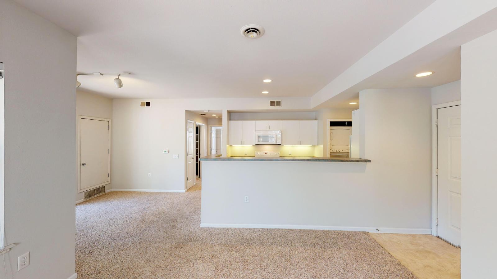 Functional kitchen with ample counter space and warm finishes in a two-bedroom at Wilson Bay