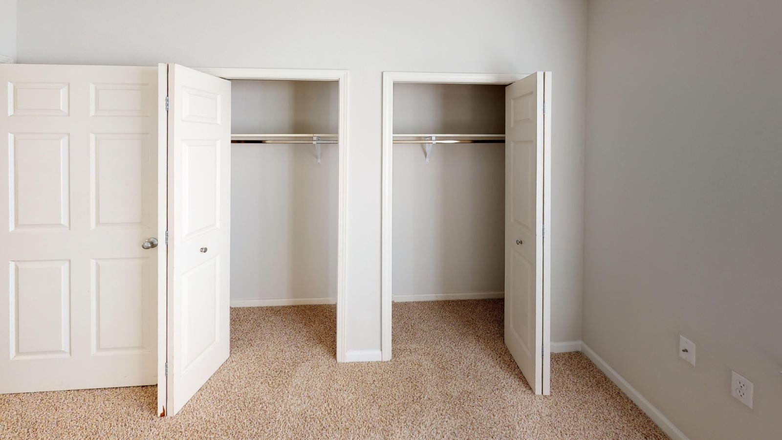 Cozy secondary bedroom with soft lighting and ample closet space at Wilson Bay Apartments