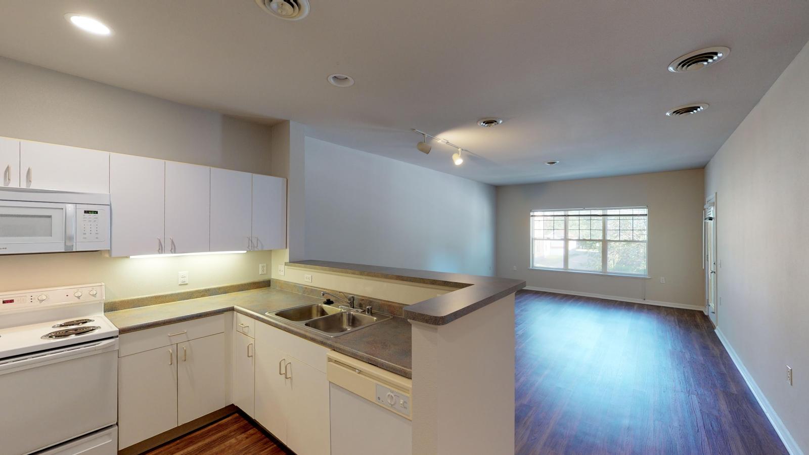 Kitchen with classic cabinetry and ample counter space in a one-bedroom at Wilson Bay