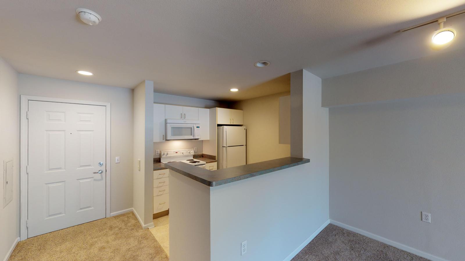 Functional kitchen with classic cabinetry and ample counter space in a studio at Wilson Bay