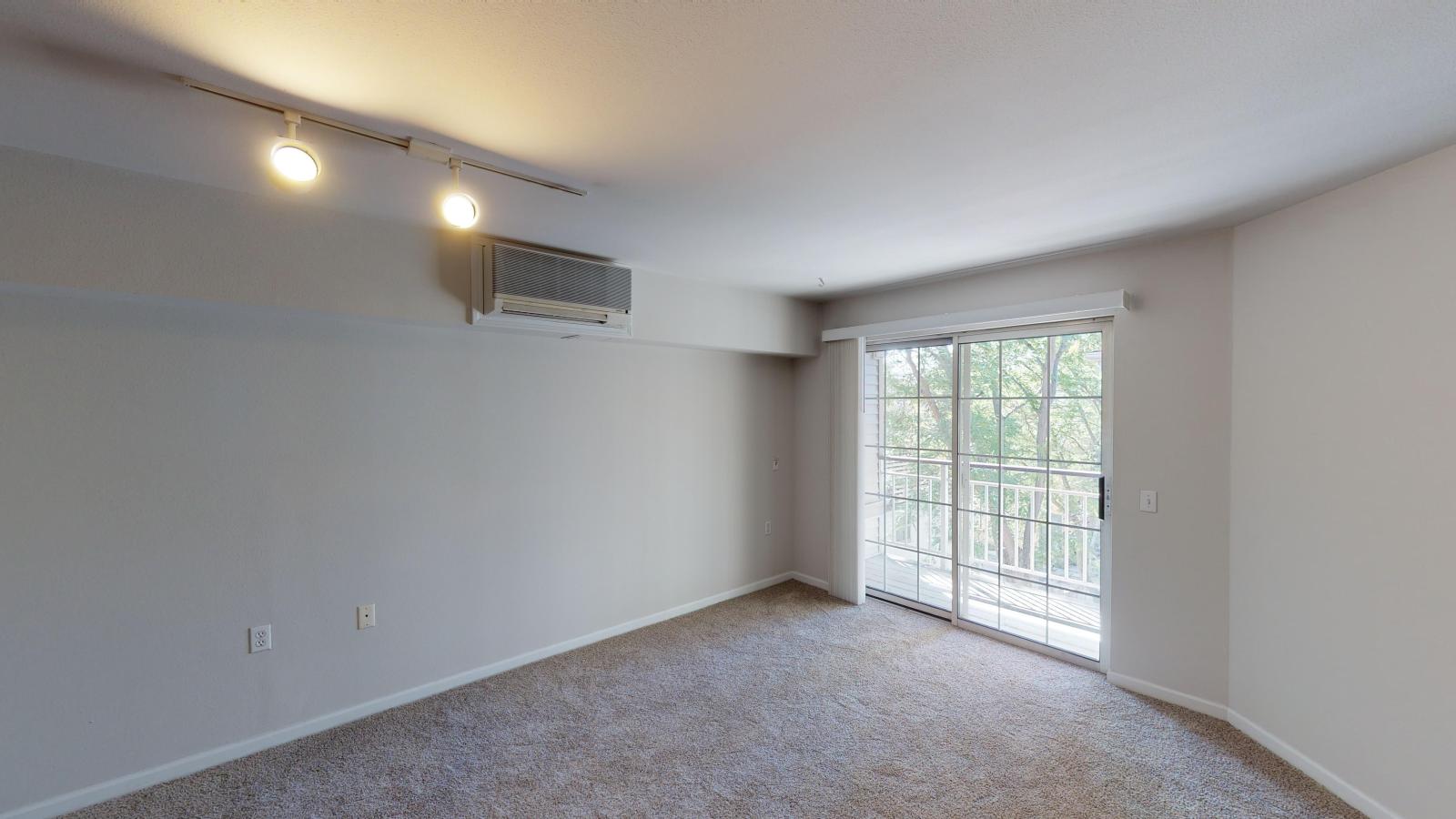 Open studio living area with soft finishes and natural light at Wilson Bay Apartments