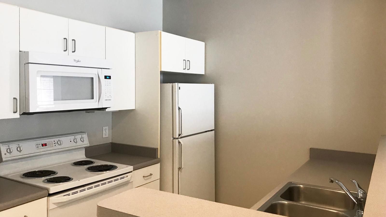 Classic-style kitchen with standard appliances and traditional cabinetry at Wilson Bay