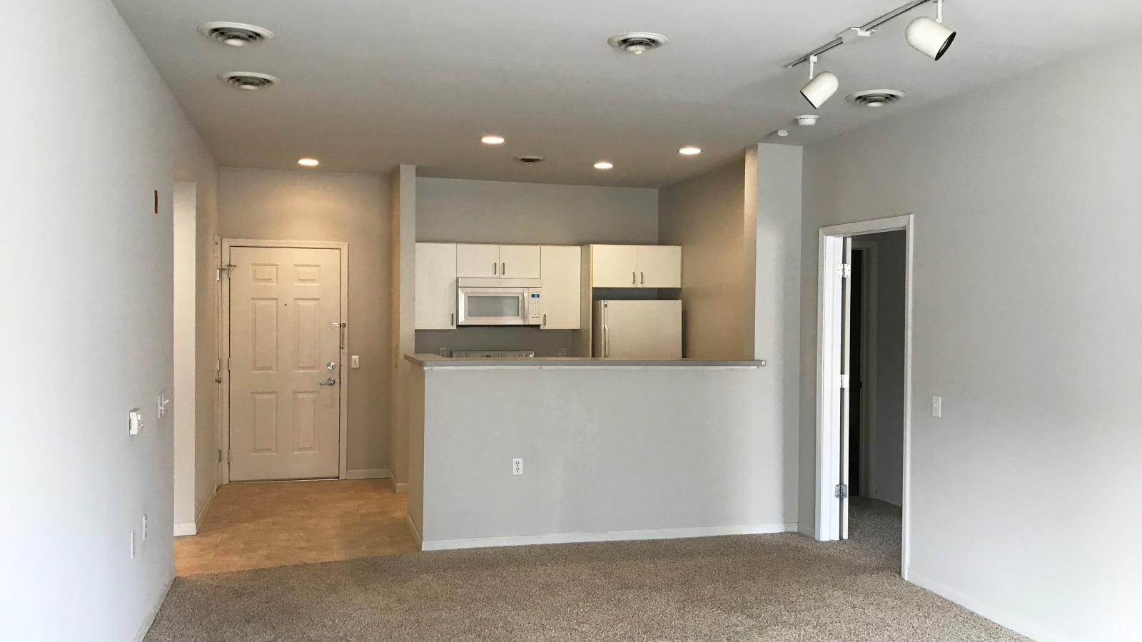 Cozy living room with soft finishes and a private balcony at Wilson Bay