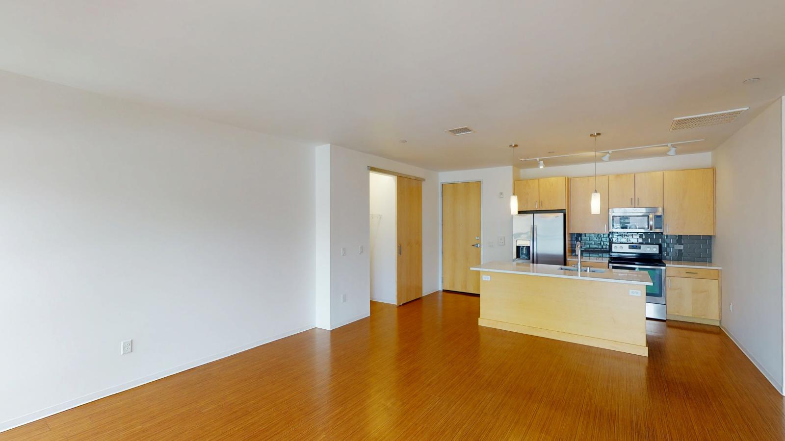 Bright modern kitchen with pendant lighting and contemporary design at SEVEN27 in downtown Madison