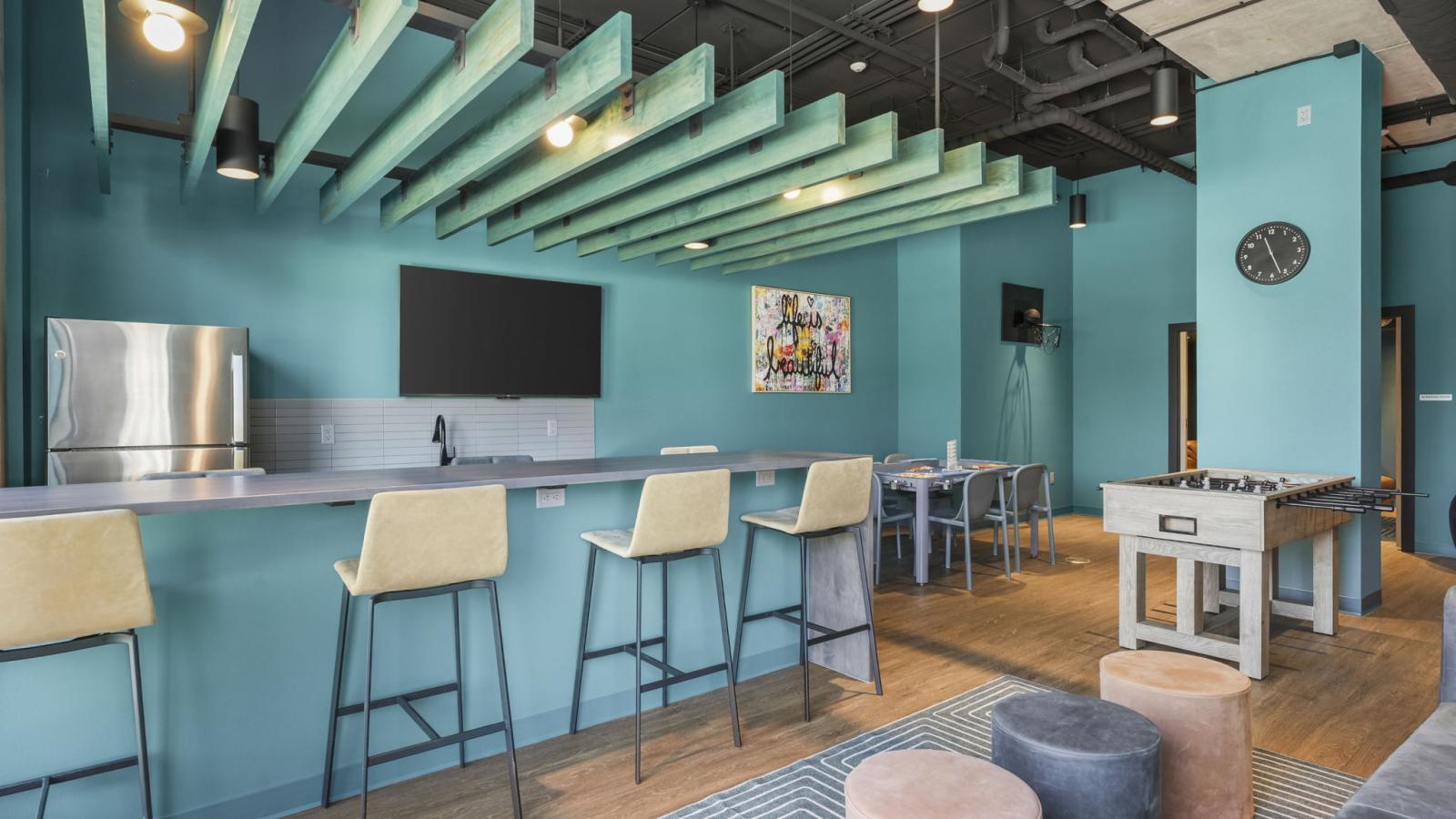 The Irwin lounge interior with modern furnishings, kitchen space, and areas for residents to connect