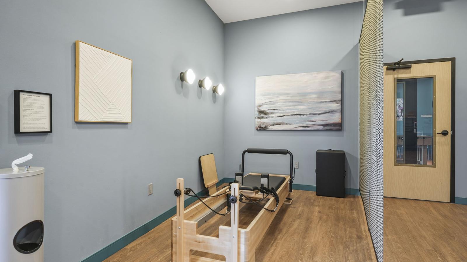 Apartment wellness room at The Irwin with Pilates equipment, sauna, and open space for exercise