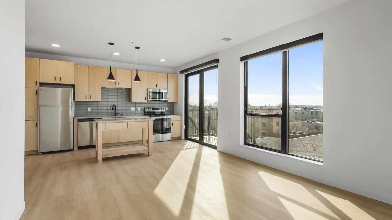 The Irwin apartment kitchen with modern cabinetry, countertops, and full appliance package