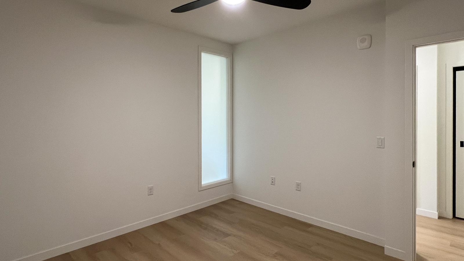 One bedroom apartment featuring spacious bedroom layout with walk in closet, ceiling fan, and modern finishes in downtown Madison