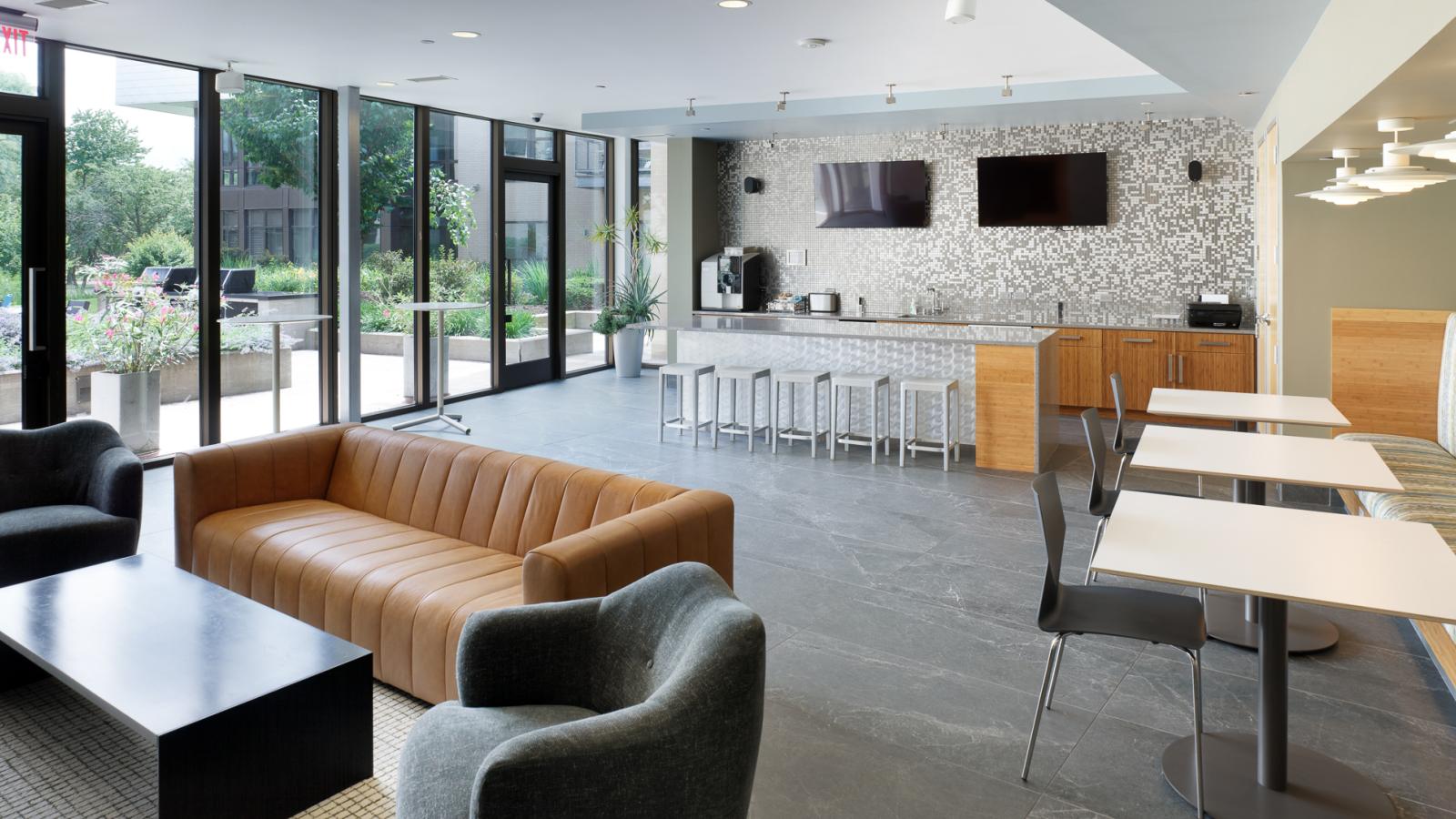 ULI Seven27 Apartments modern lounge with stunning natural light, ample seating and outdoor access in downtown Madison