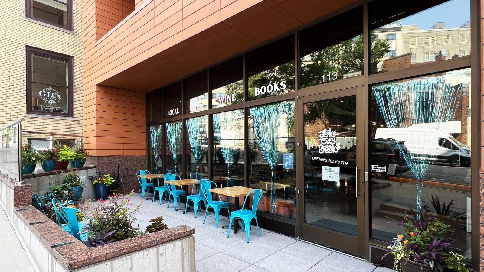 Lake City Books exterior with cozy patio next to The Pressman Apartments 