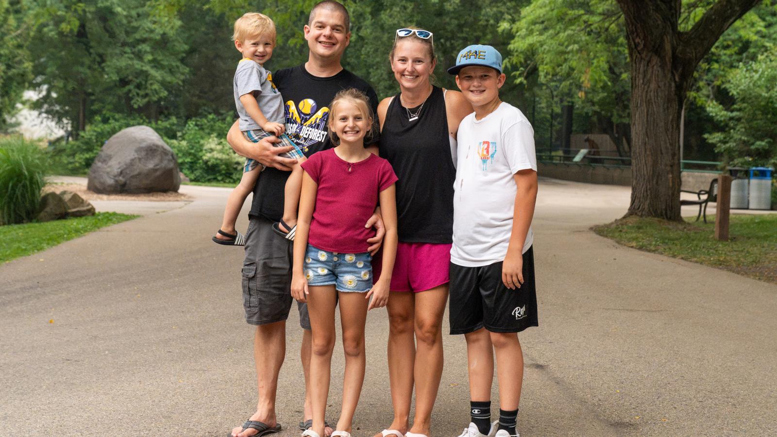 An Urban Land Interests employee and family members posing together during the annual company picnic at Henry Vilas Zoo