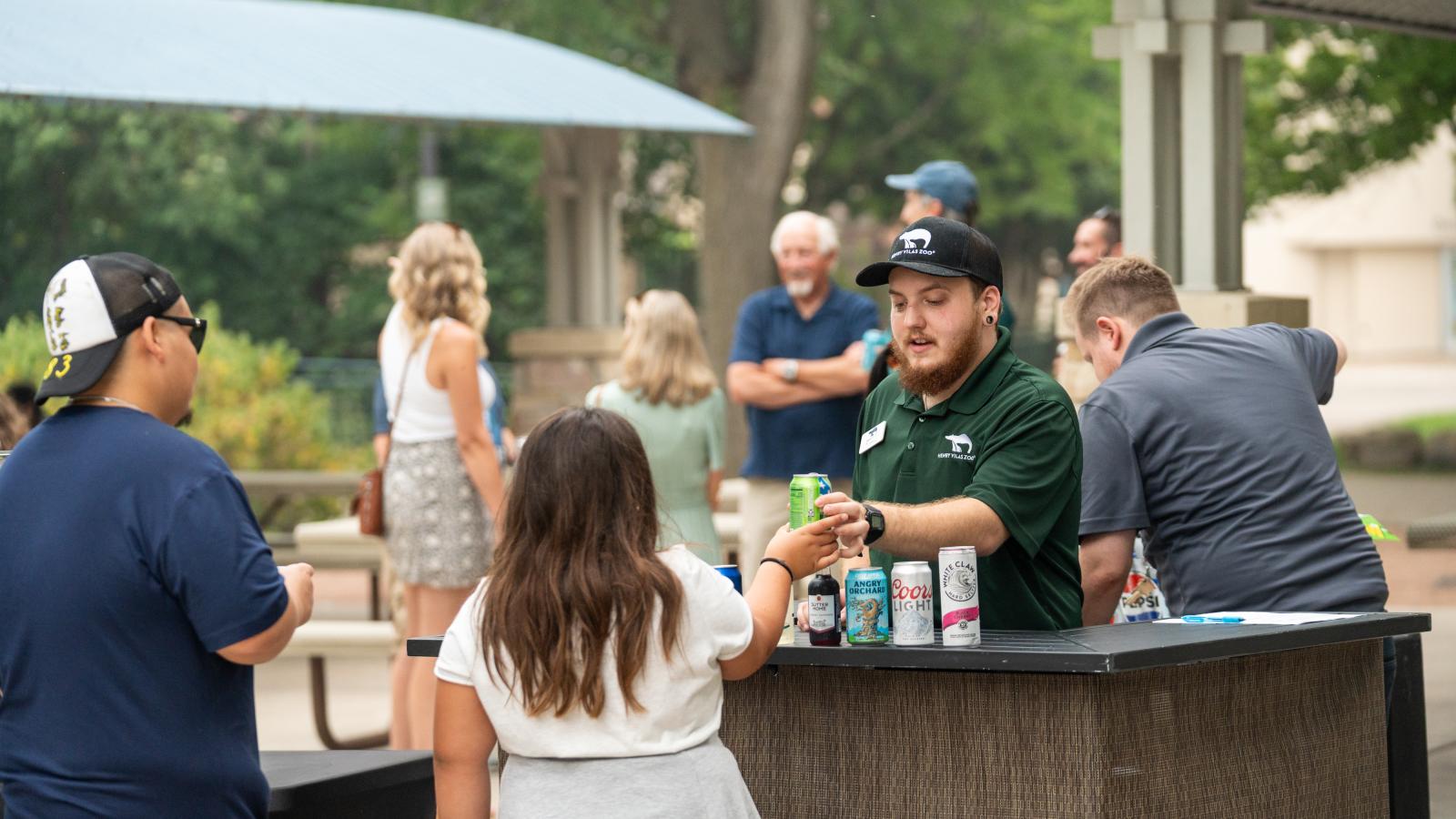 Guests receiving refreshments during the Urban Land Interests annual company picnic at Henry Vilas Zoo