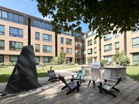 Quarter Row Apartments lush and serine landscaped courtyard is the perfect space to get away, grill out dinner, and cozy up around the fireplace 