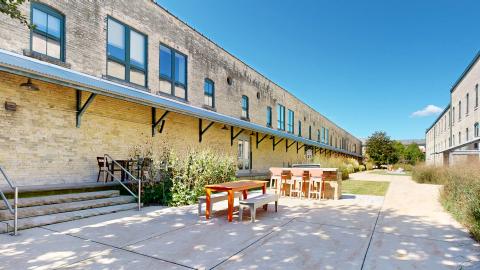 The Tobacco Lofts grill patio with built-in gas grill makes the perfect space to grill up dinner, and host a gathering with friends or neighbors in this beautiful historic apartment community 